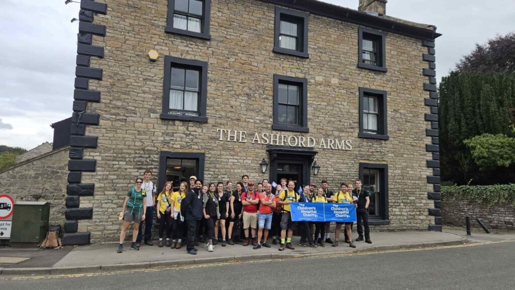 The team stood outside The Ashford Arms after completing the 29KM walk